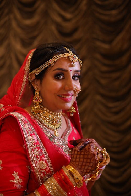Smiling Bride in Golden Jewelry and Traditional Wedding Clothing 