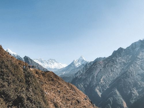 Free A stunning view of the Himalaya Mountains with hikers traversing the scenic mountain path in Nepal. Stock Photo