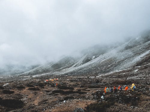 Group of Hikers Descending to the Camp in the Valley