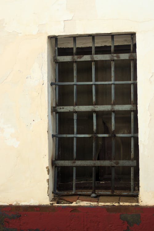Close-up of a Barred Window in an Old Building 