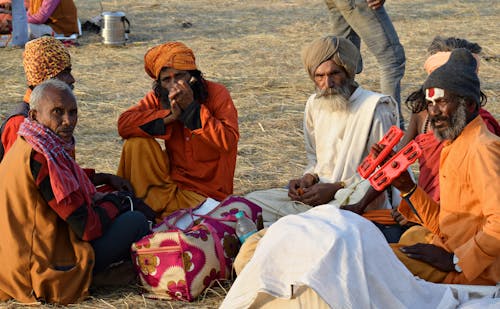 Group of Men in Turbans Sitting on the Ground 