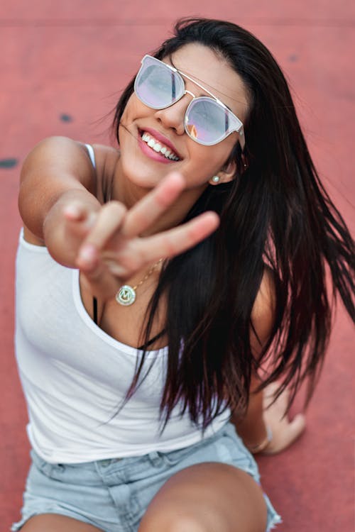 Woman Smiling and Peace Sign