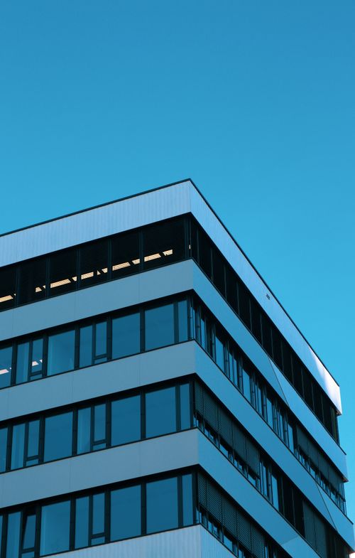 Free A striking modern building with geometric design and windows under a clear blue sky in Vienna, Austria. Stock Photo