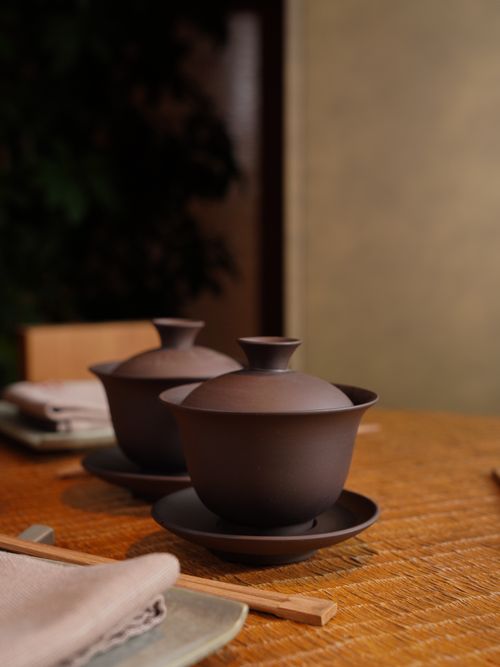 Free Minimalistic brown ceramic tea cups placed on a wooden table in a cozy setting. Stock Photo