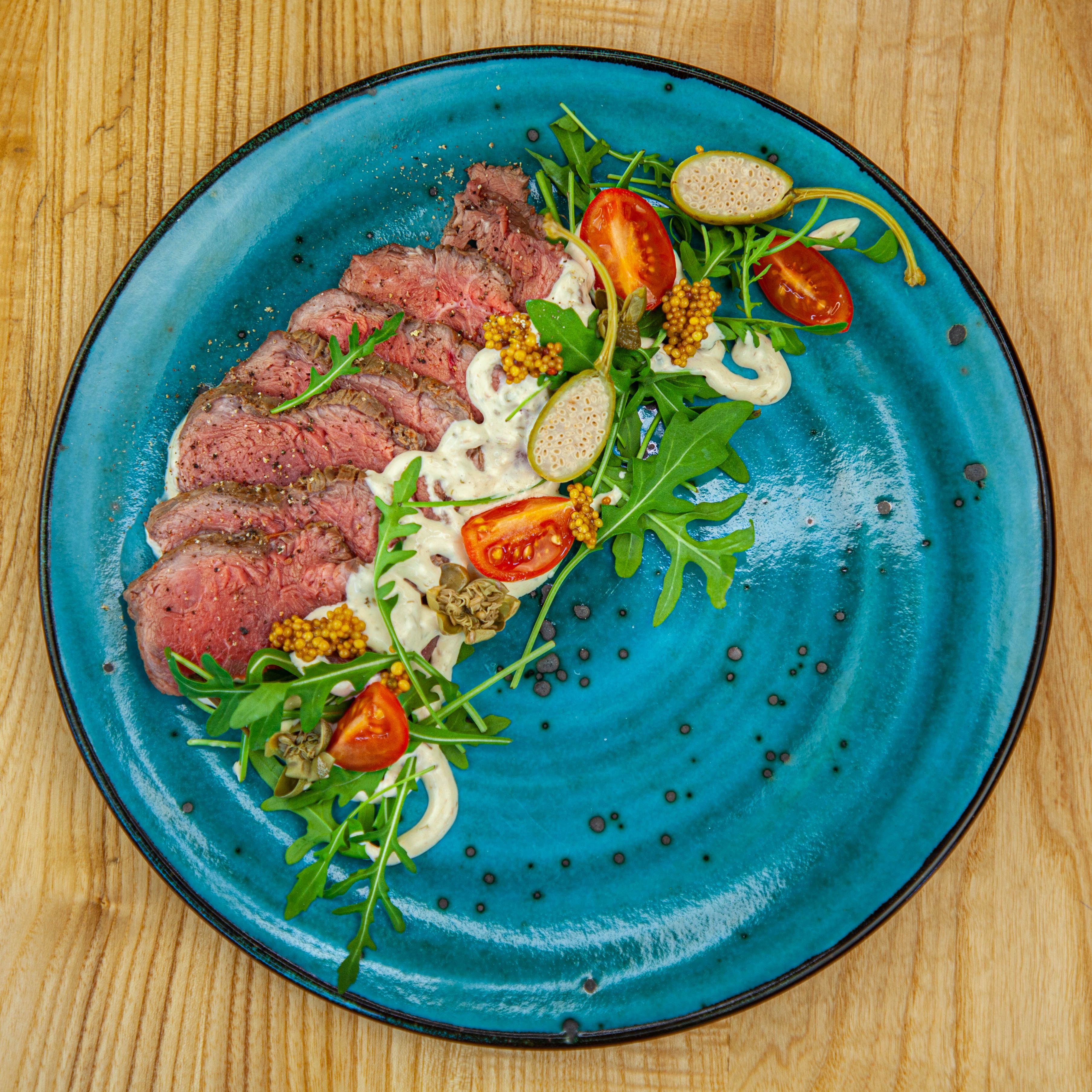 Gourmet beef with sauce and garnish