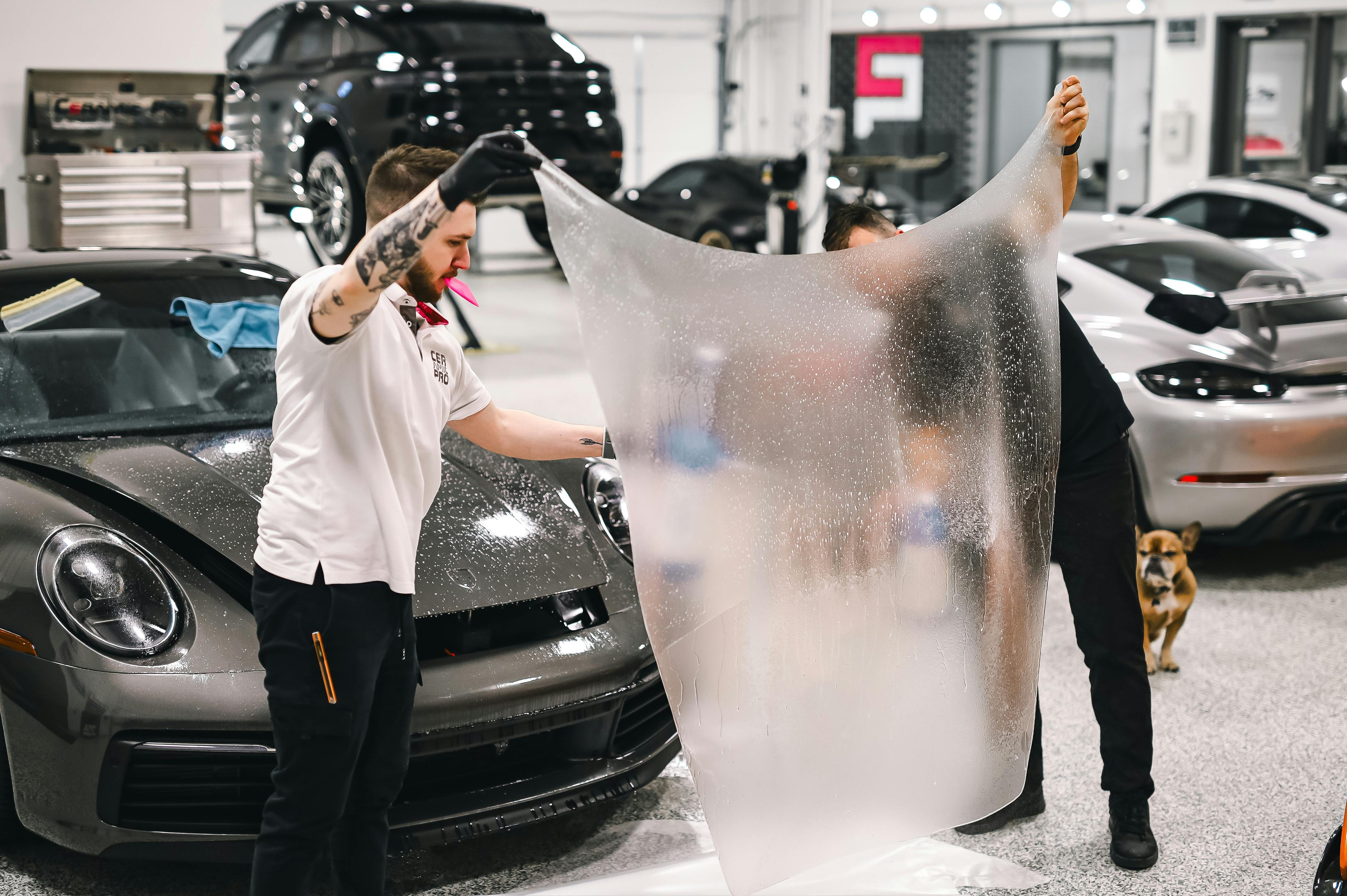 Men Holding Foil in Garage · Free Stock Photo