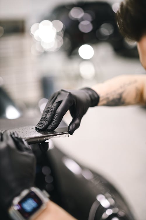 Mechanic Hand in Glove Working on Car