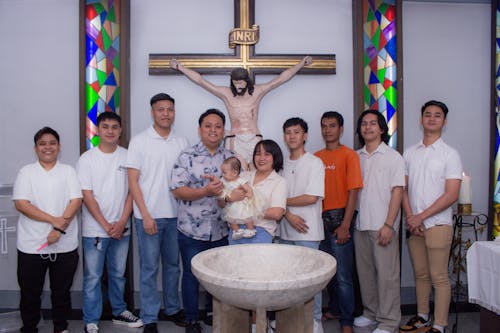 Free A group of people standing in front of a baptismal Stock Photo