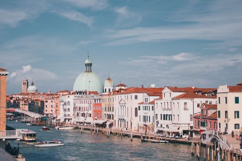 Explore the iconic cityscape of Venice's Grand Canal with stunning architecture and vibrant colors.