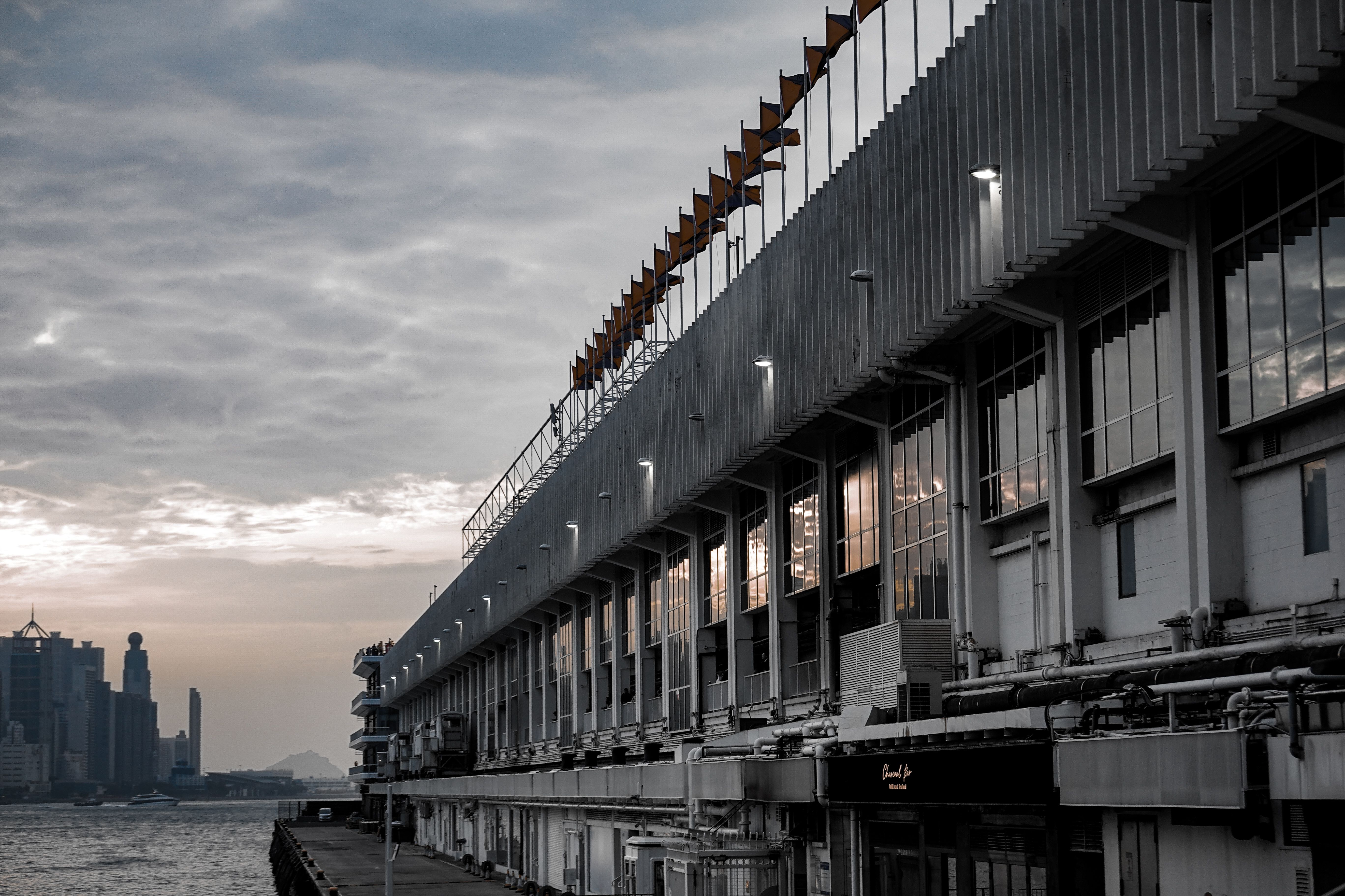 Hong Kong racecourse grandstand overlooking the track at sunset, racing form guides on seats