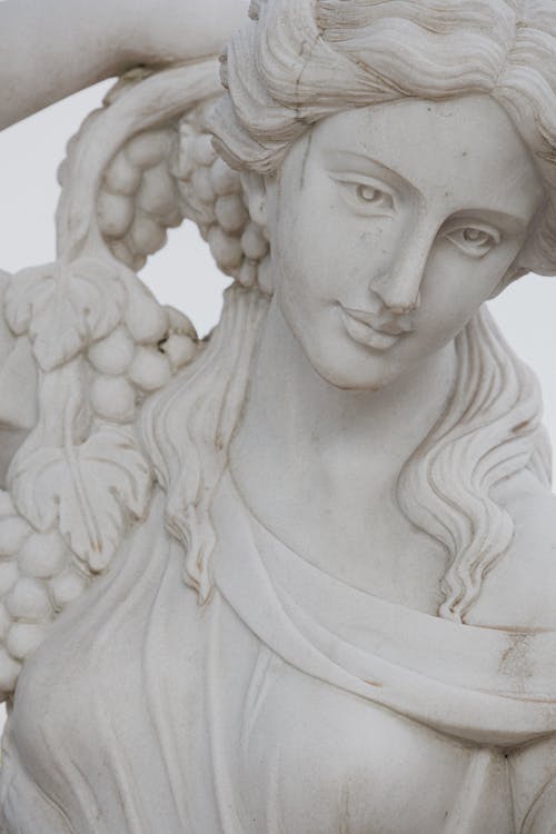 Close-up of a Statue of a Woman Holding Grapes 