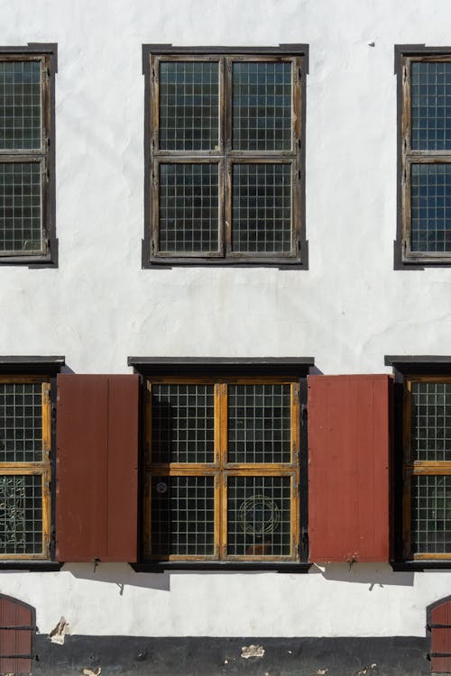 Free Exterior of an Old Building with Window Shutters  Stock Photo