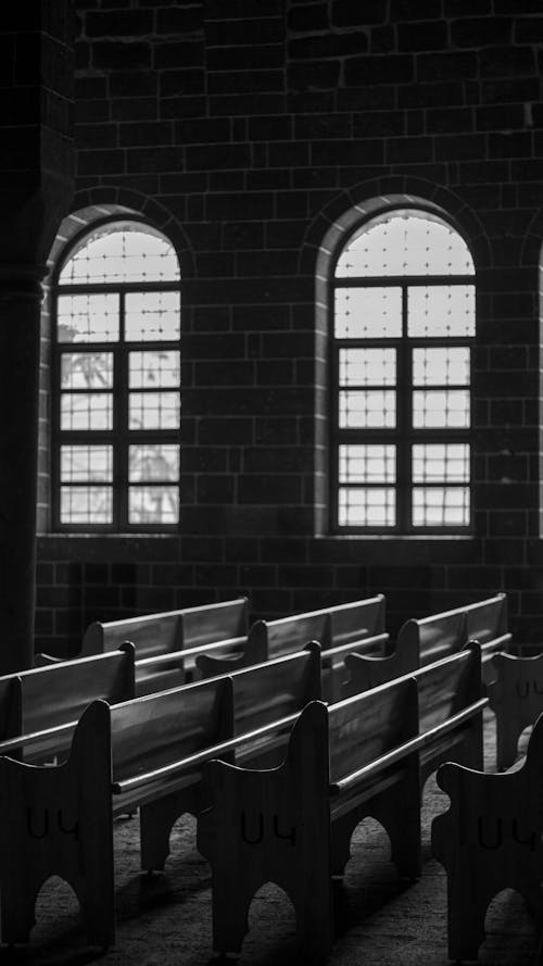 Black and white photo of empty church pews