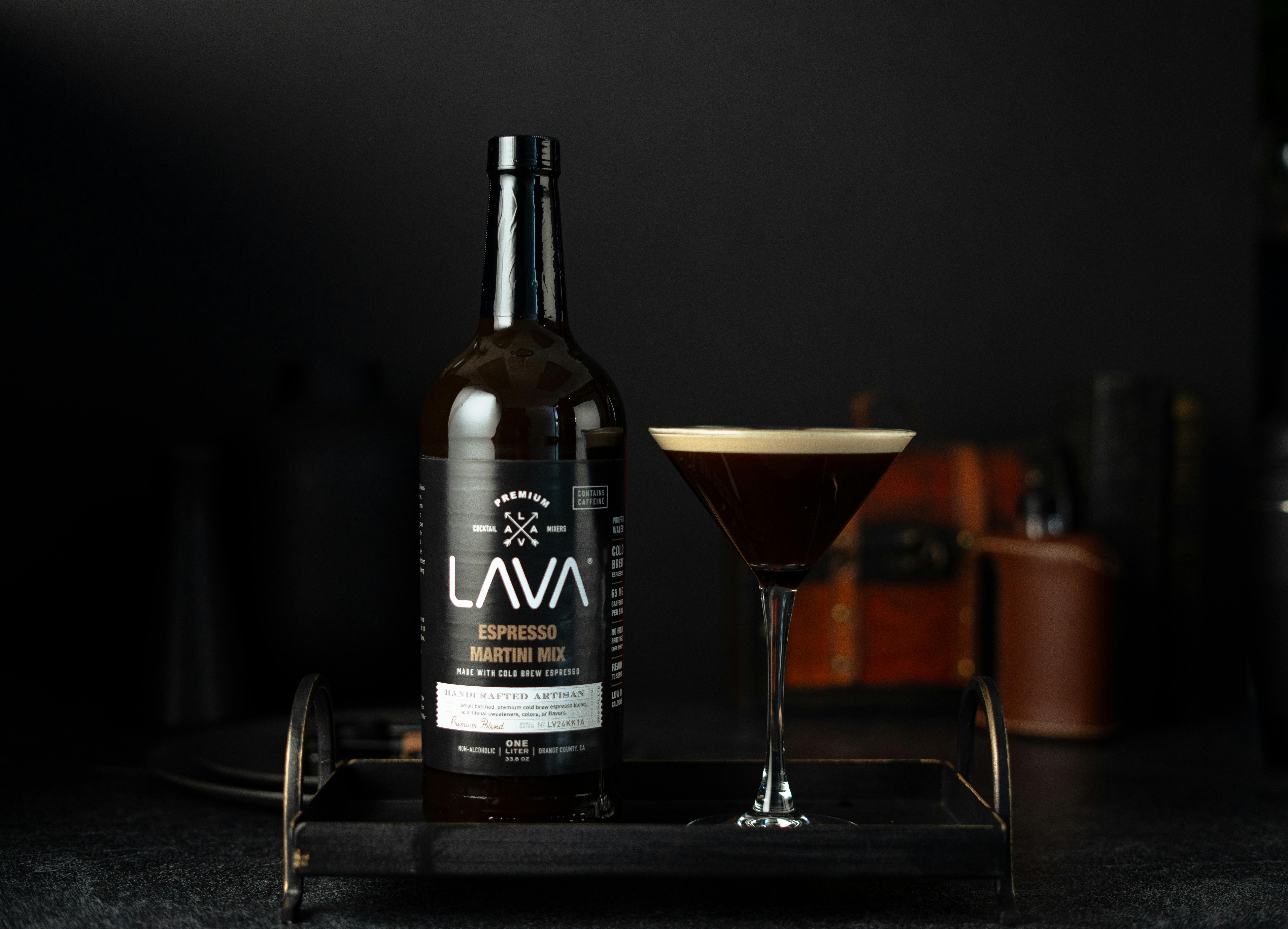 Luxurious espresso martini mix showcased with a glass against a dark background.
