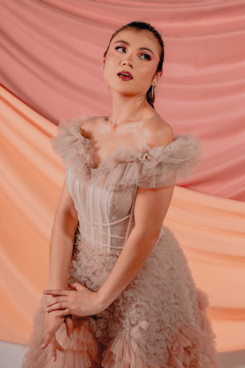 Studio Shot of a Young Woman Wearing a Light Pink Tulle Dress 