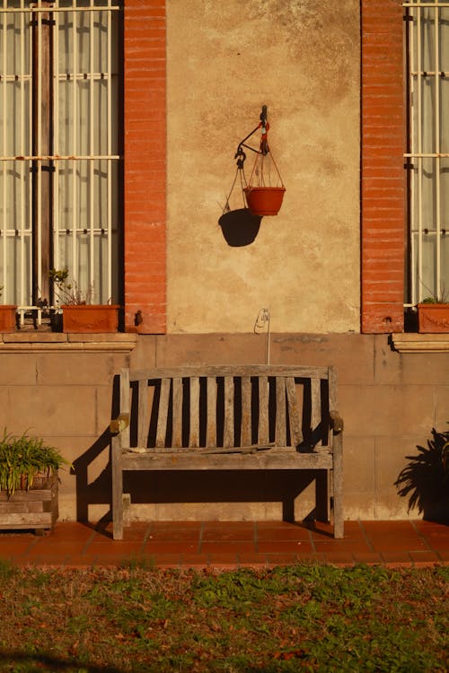 Sunlit Bench by Building Wall