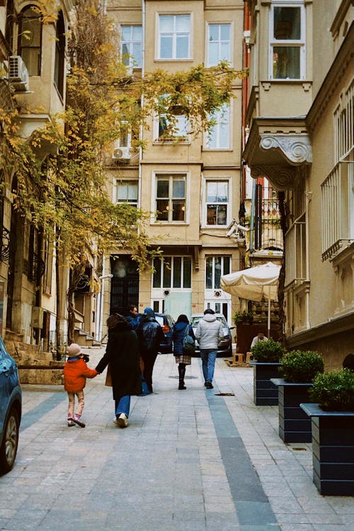 People Walking in Alley in City