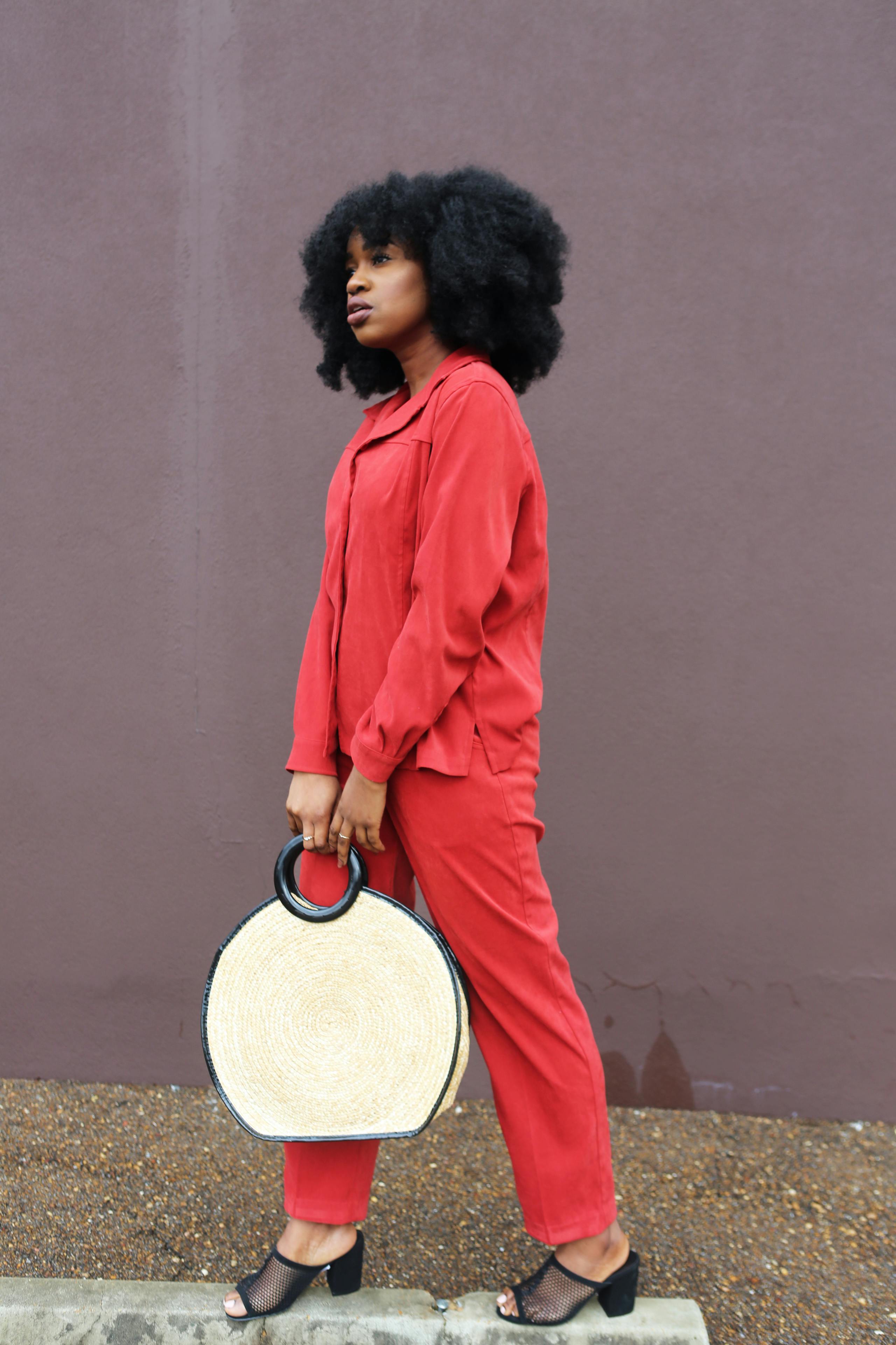 woman holding white handbag