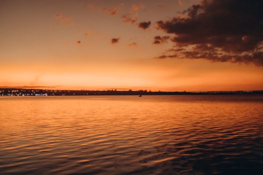 A breathtaking sunset with vibrant orange hues over a tranquil coastal sea view, perfect for nature lovers.