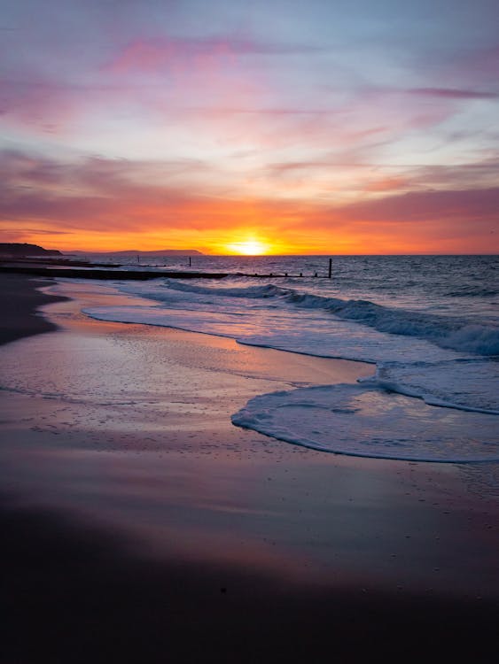 Waves on a Beach During Sunset 