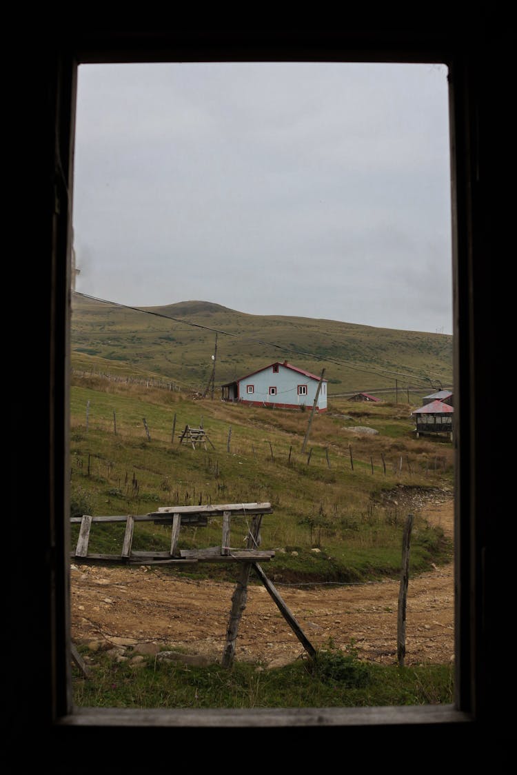 Hut On A Field Seen From A Window