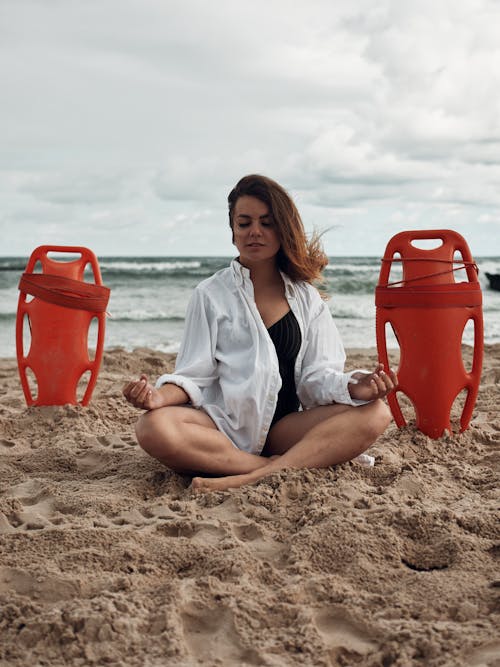 Woman Meditating on a Beach 