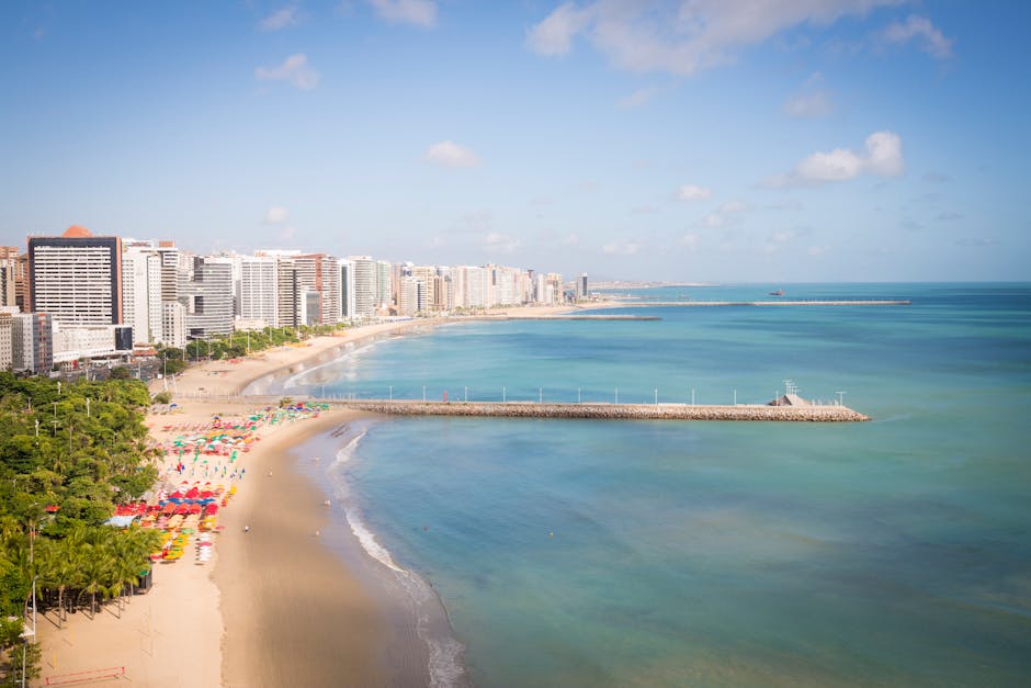 Aerial shot of Fortaleza's vibrant beach, sandy shores, and city skyline in Brazil.
