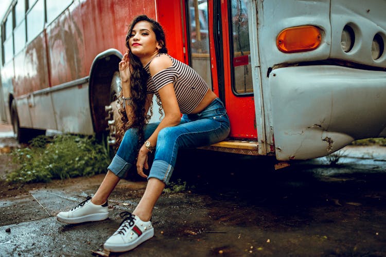 Woman Sitting On Bus Steps