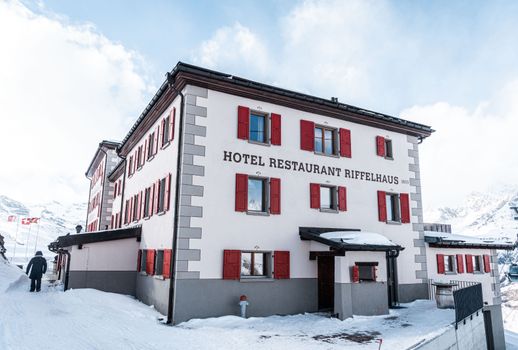 Scenic view of Hotel Riffelhaus 1853 nestled in the snowy Swiss Alps.