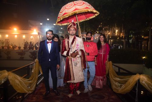 Free An Indian groom with family and friends in traditional attire during a nighttime wedding procession. Stock Photo