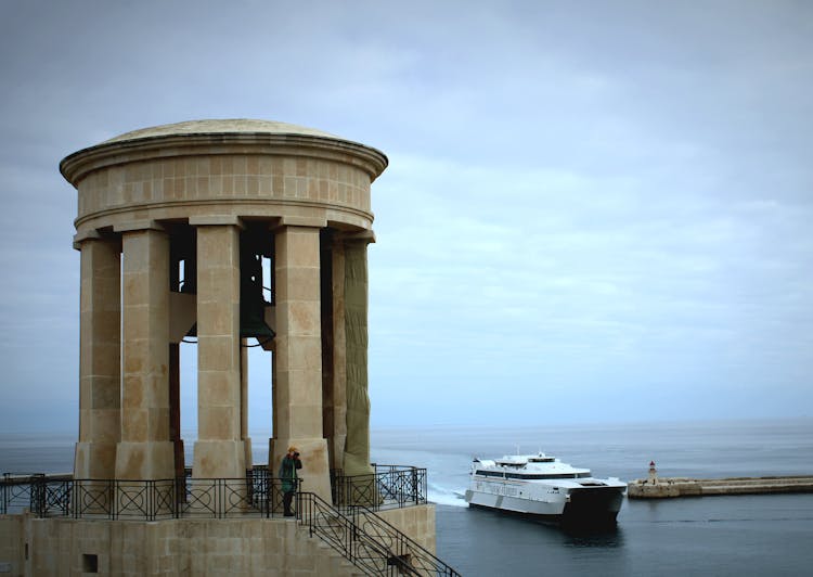 Siege Bell War Memorial And A Ship On The Sea