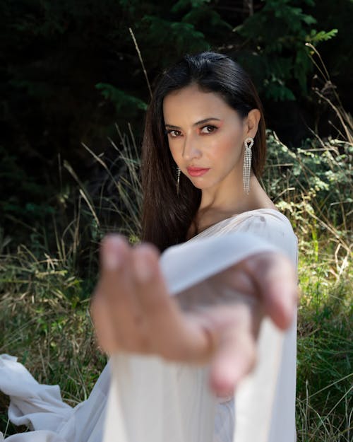 Elegant Brunette Reaching Out Hand to the Camera