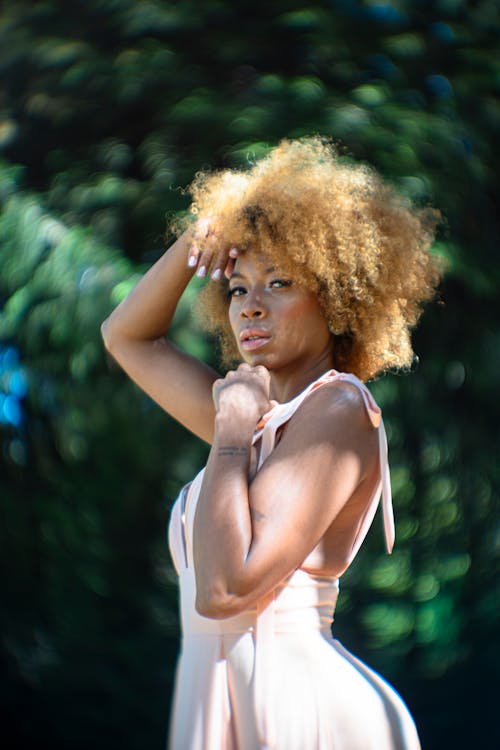 Free Photo of a Model with Afro Hairstyle, Posing in a Park Stock Photo