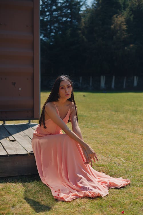 Woman Sitting in Pink Dress
