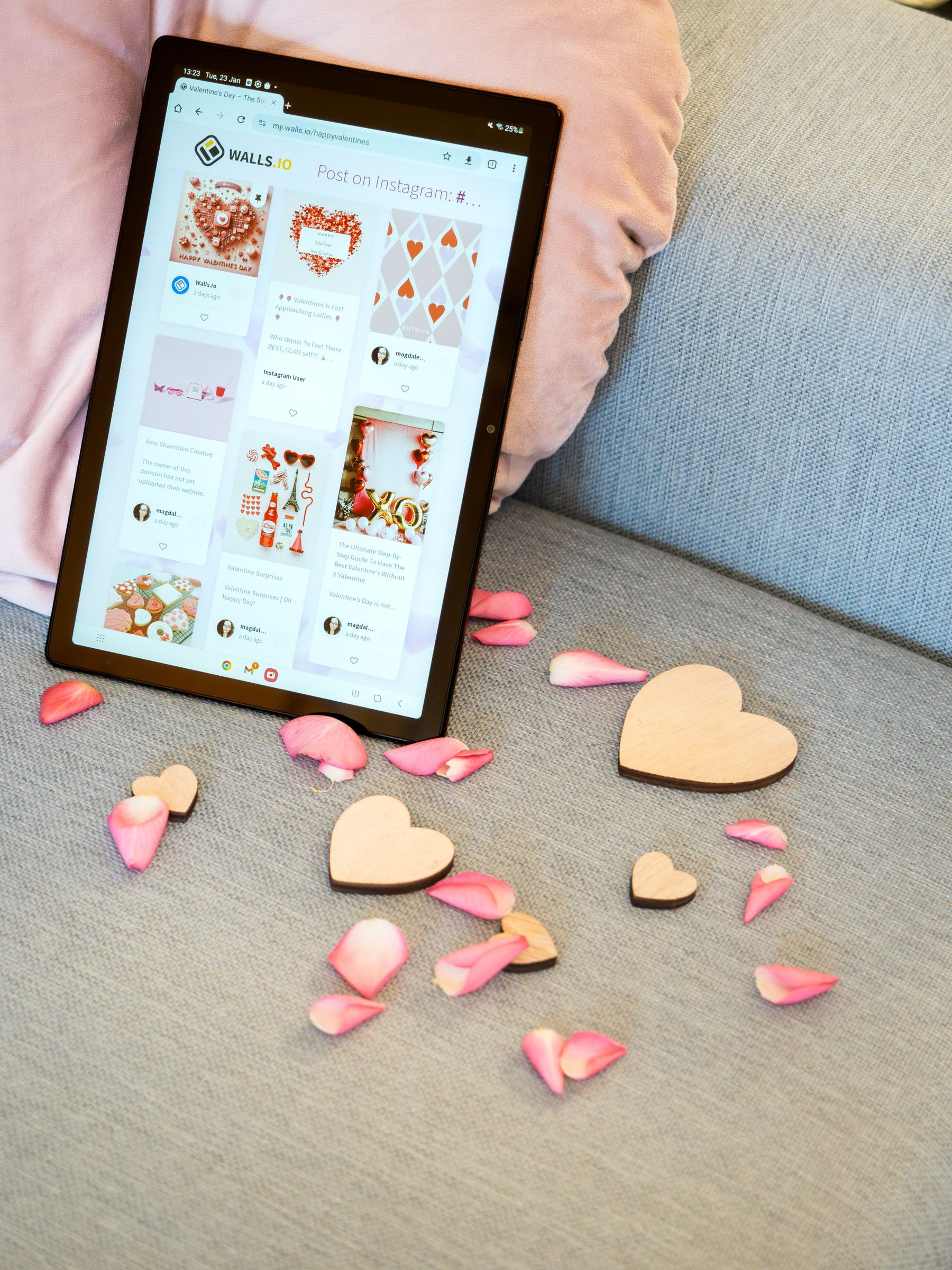 Living room sofa with heart decorations, rose petals and a tablet