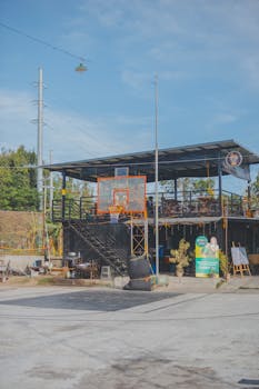 A modern urban café with a basketball hoop, offering a unique leisure space outdoors.