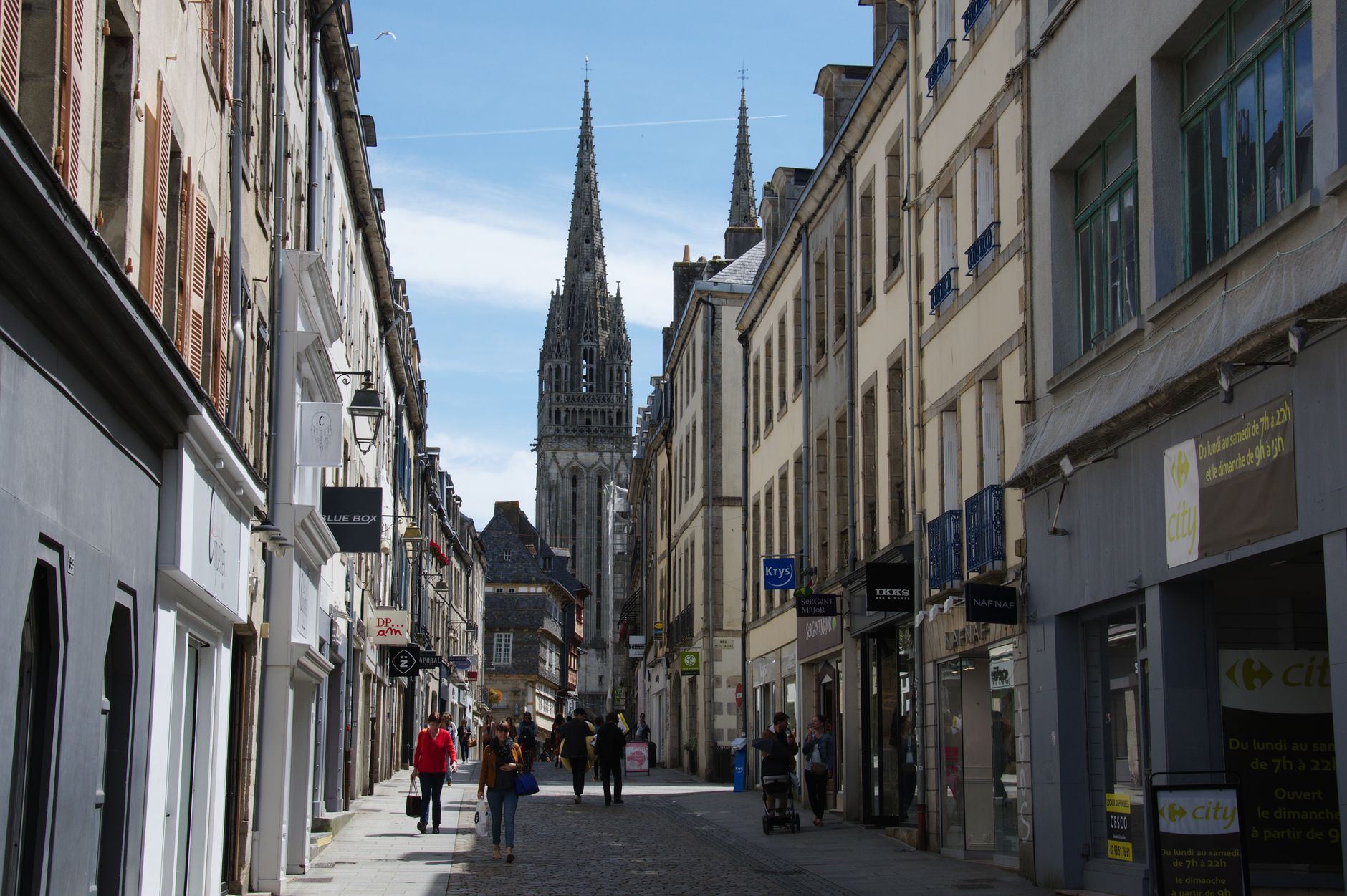 Explore the bustling streets of Quimper, France, showcasing gothic architecture and local life.