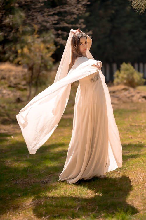 Model in White Dress on Grass