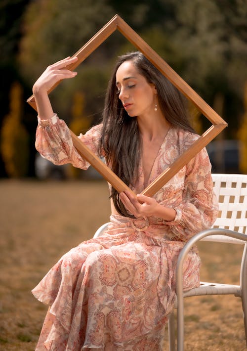 A woman holding a frame in her hand
