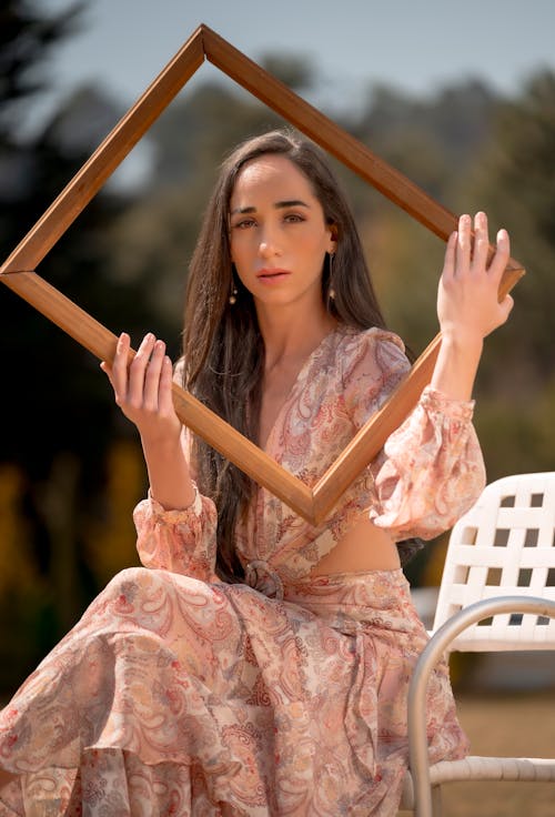 A woman holding a frame in her hands