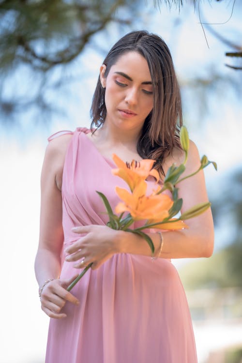 Woman in Pink Dress and with Flowers