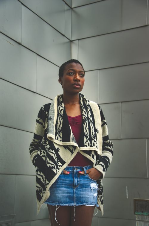 Free A stylish woman poses confidently in a modern urban setting wearing a trendy ensemble. Stock Photo