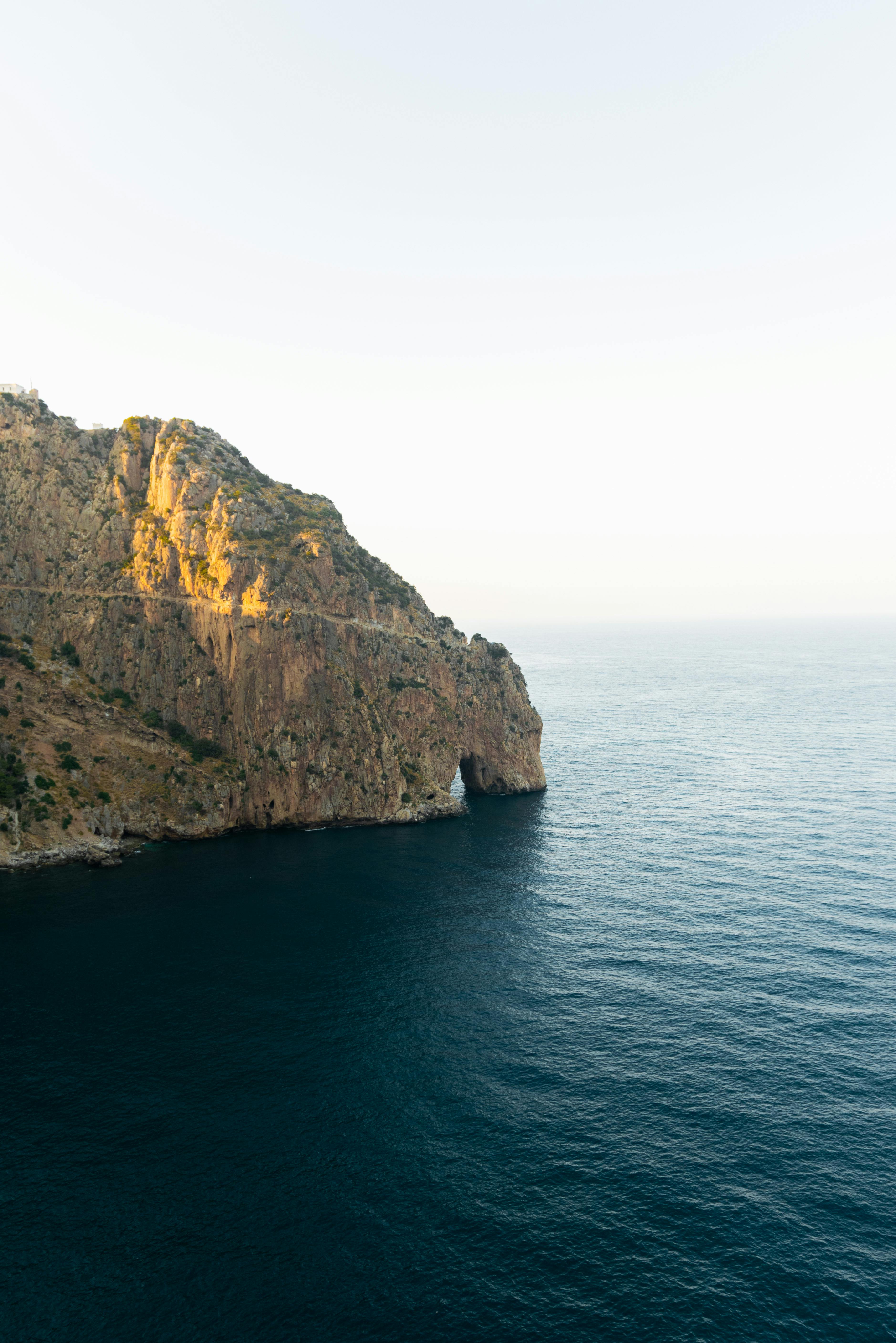 Dramatic cliffs and serene sea view in Béjaïa, capturing natural beauty and tranquility.