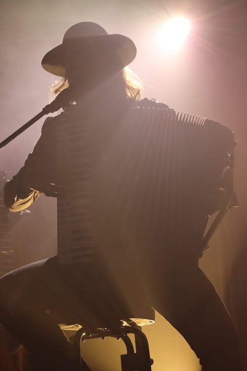 Light over Man Sitting and Playing Accordion