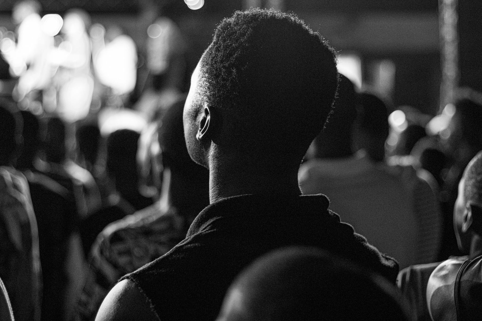 Grayscale image capturing a crowd focused on a concert in Brazzaville.