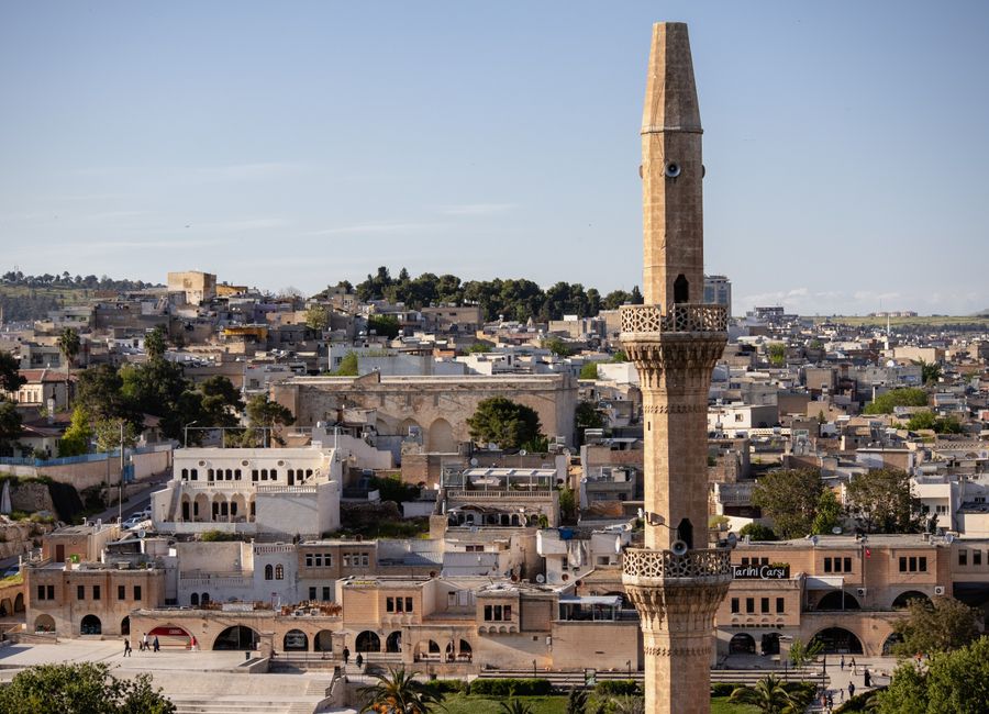 Panoramic view of Şanlıurfa showcasing its urban landscape and a prominent mosque minaret.