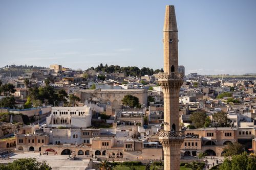 Free Panoramic view of Şanlıurfa showcasing its urban landscape and a prominent mosque minaret. Stock Photo