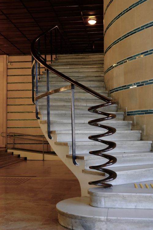 Free Elegant spiral staircase with a sleek handrail in a modern interior setting. Stock Photo