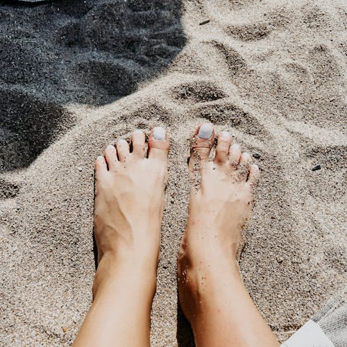 Woman Feet on Beach Sand