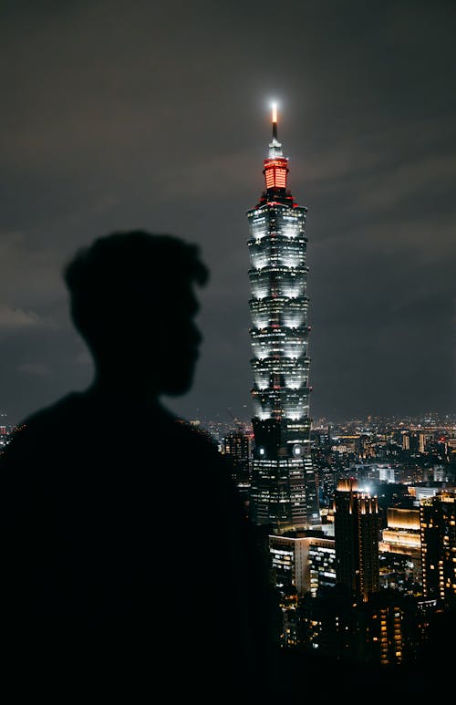 Taipei 101 behind Man Silhouette at Night